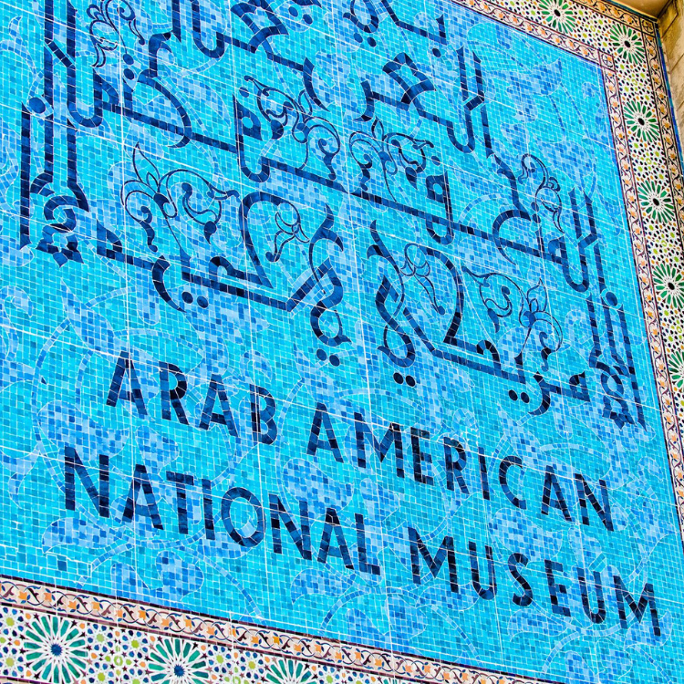 Mosaic Sign made of blue tiles, text: Arab American National Museum