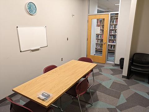 Room with a table and four chairs.