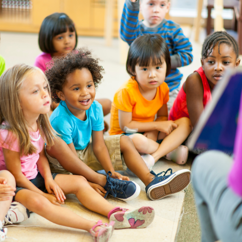 Children sitting on the floor listening to a story