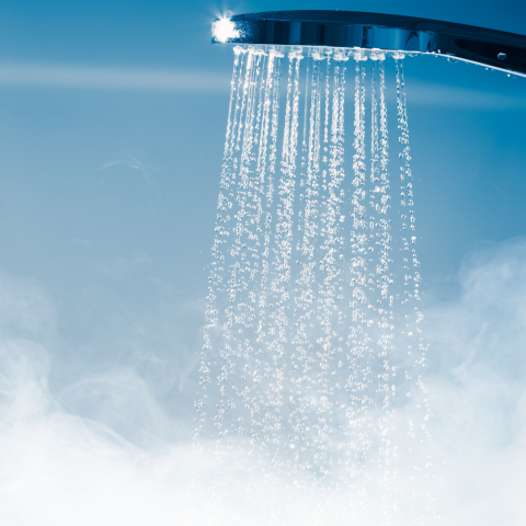 Shower head with hot steamy water coming out.