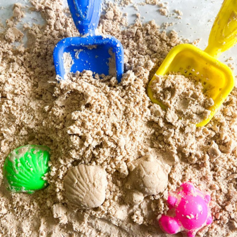 sand with two shovel and shells