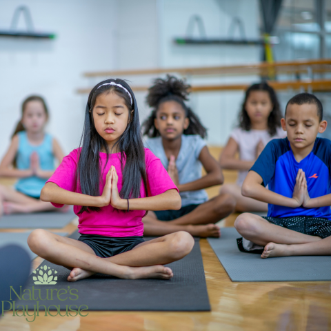 children seated on yoga mats