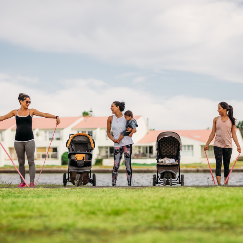 three woman with babies in strollers exercising 