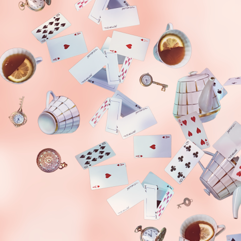 Playing cards, keys, and tea cups fall on a pink background