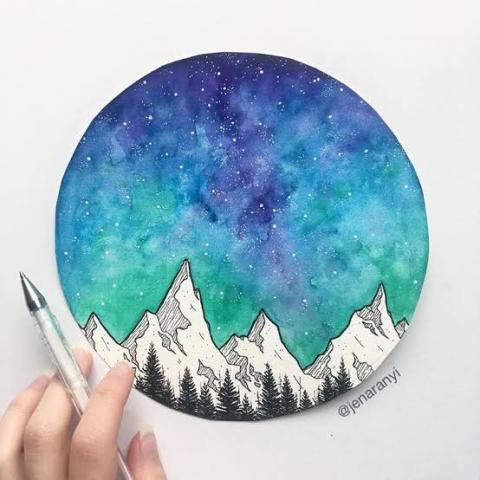 Round watercolor painting in purple, blue and green with black and white line art mountains credited to Jen Aranyi