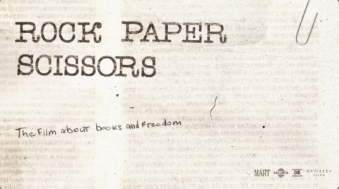 grayish-white background, written: "Rock, Papers, Scissors" and "The film about books and freedom"