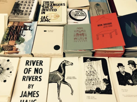 assortment of chapbook of poetry on a table 