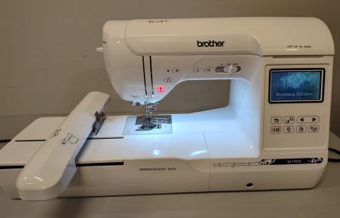 Brother SE 1900 model sewing machine with light on and white background.