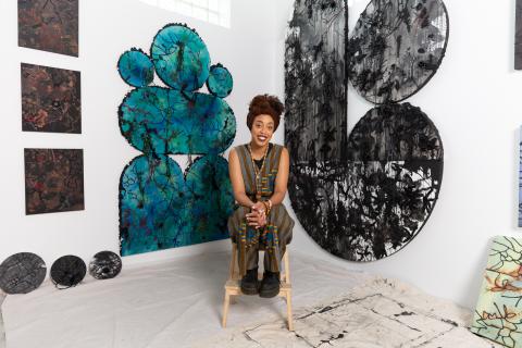 picture of Olivia Guterson in gallery with her work