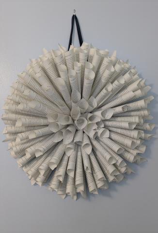 A picture of a wreath made out of book pages