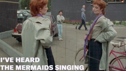 A woman with red hair looks at herself in a mirror, and in the bottom left it reads "I"ve Heard the Mermaids Singing"