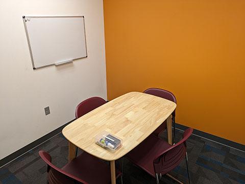 Room with a table and four chairs.