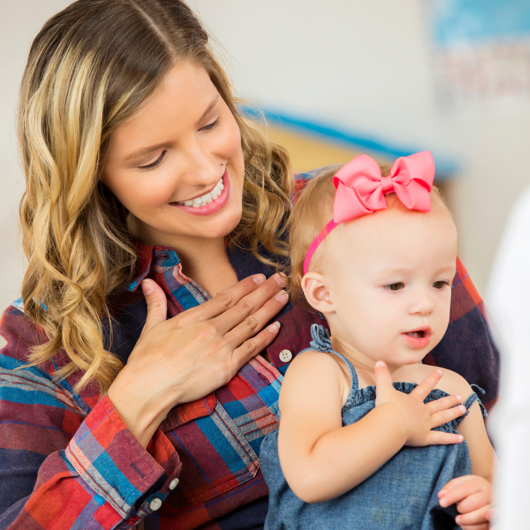 mom and baby doing sign language