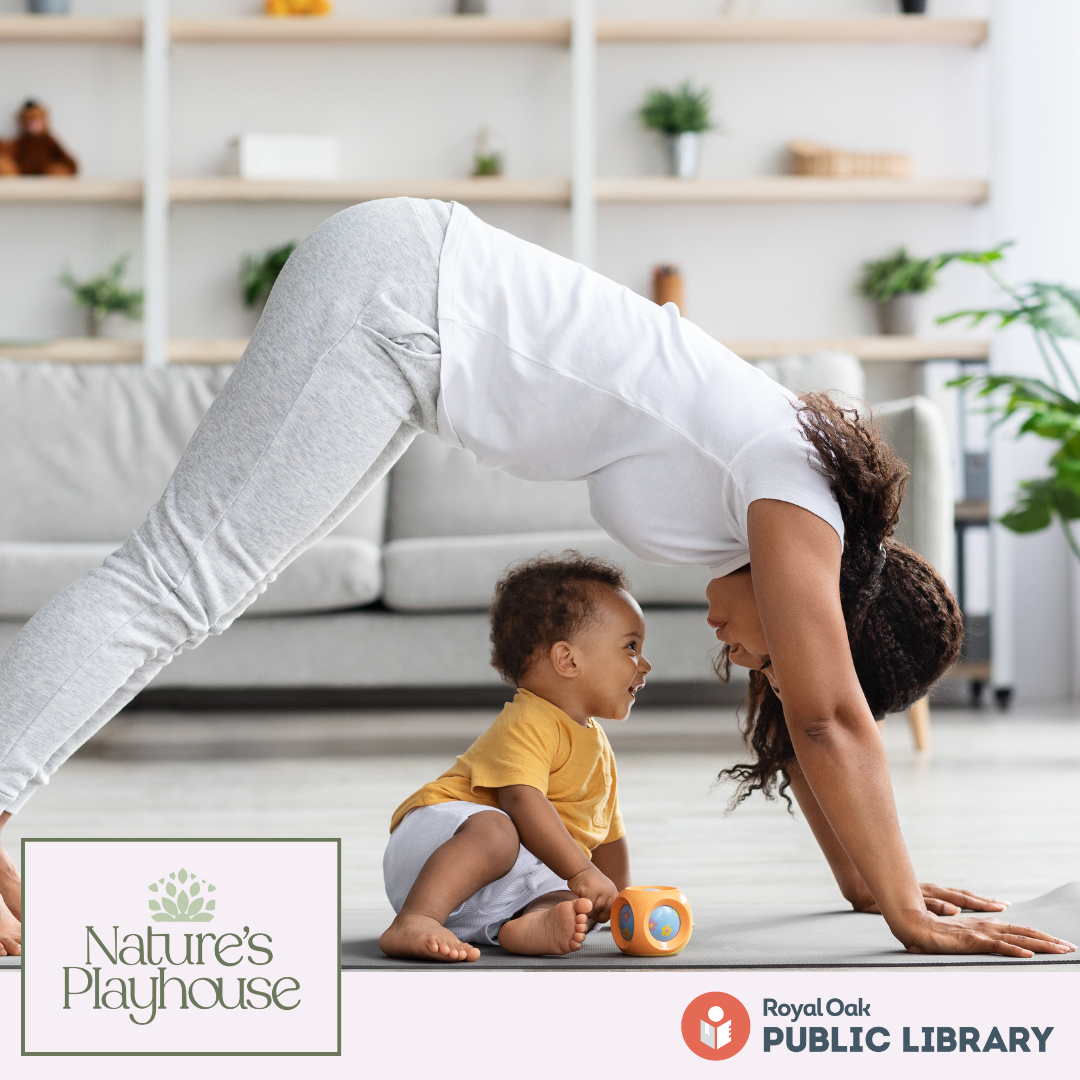 woman in downward dog pose over a baby 